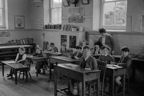 A black and white image of children in a classroom.