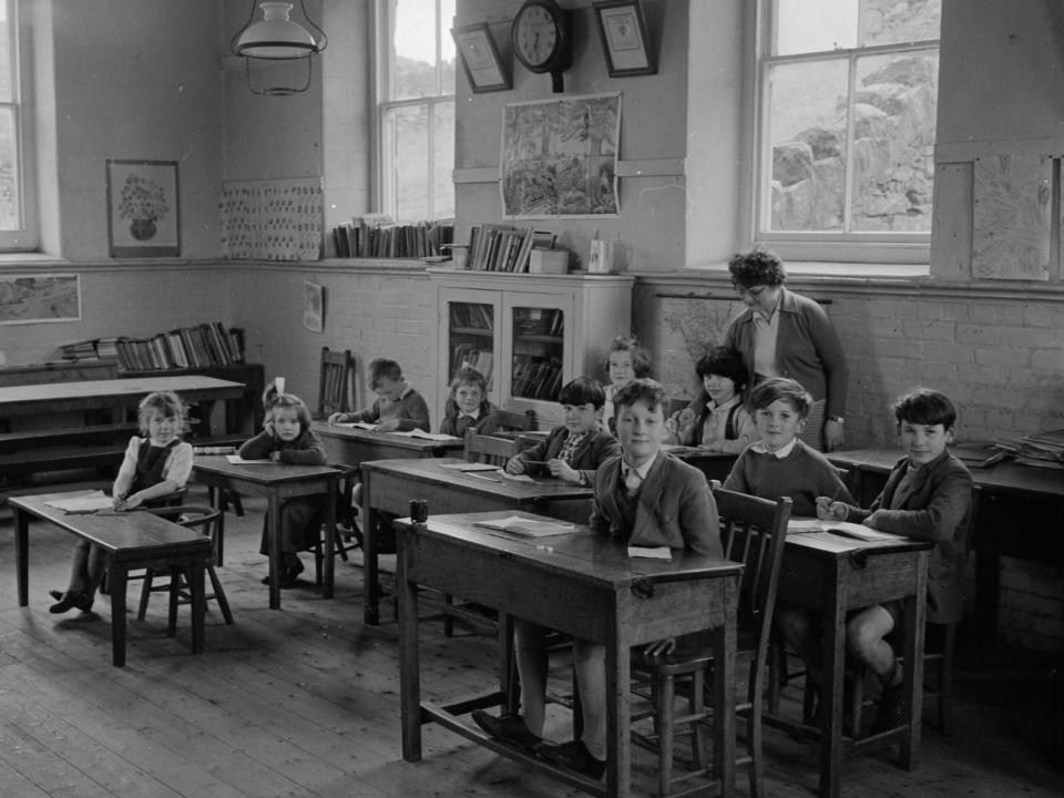A black and white image of children in a classroom.